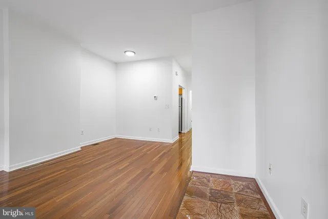 a view of hallway with wooden floor