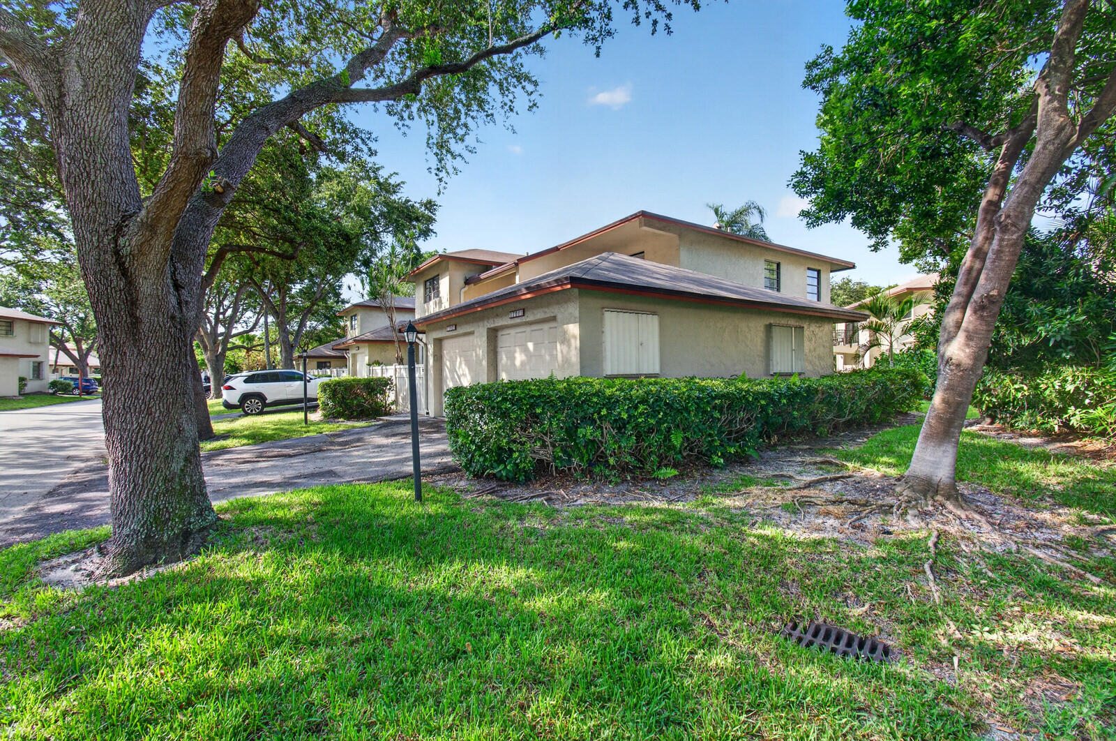 3951 Northeast 19th Road, Unit 1701 Pompano Beach, FL 33064 - Photo 75 of 82 a view of a house with a backyard and a tree