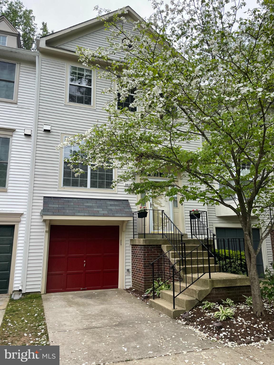 5833 Pin Oak Commons Court Burke, VA 22015 - Photo 1 of 15 a front view of a house with a garden