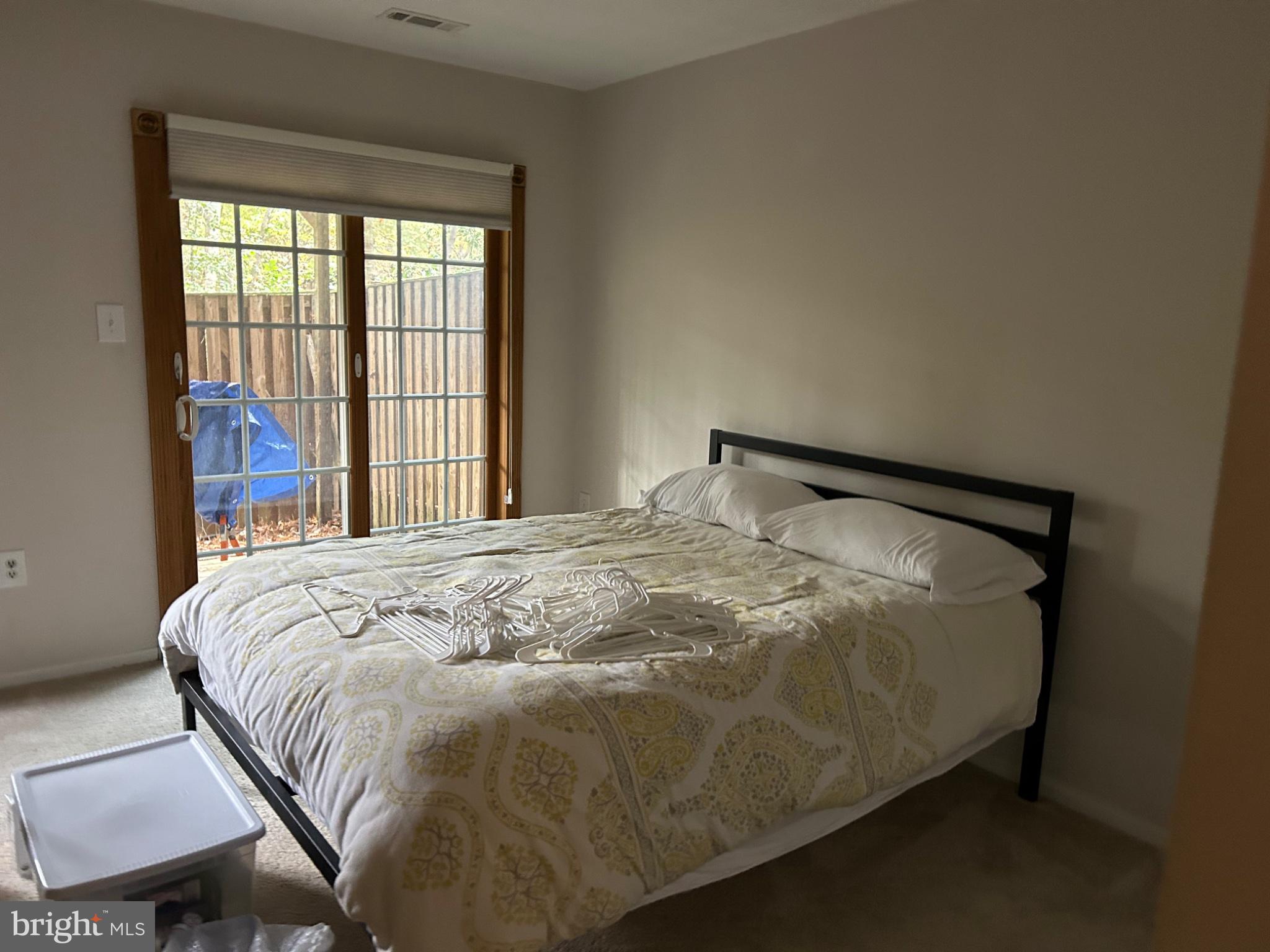 5833 Pin Oak Commons Court Burke, VA 22015 - Photo 15 of 15 a bed sitting in a bedroom next to a window