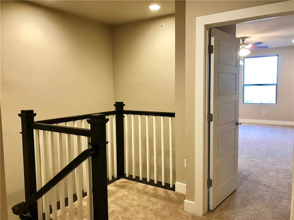 6814 East Riverside Drive, Unit 95 Austin, TX 78741 - Photo 19 of 23 a view of a hallway with wooden floor and stairs