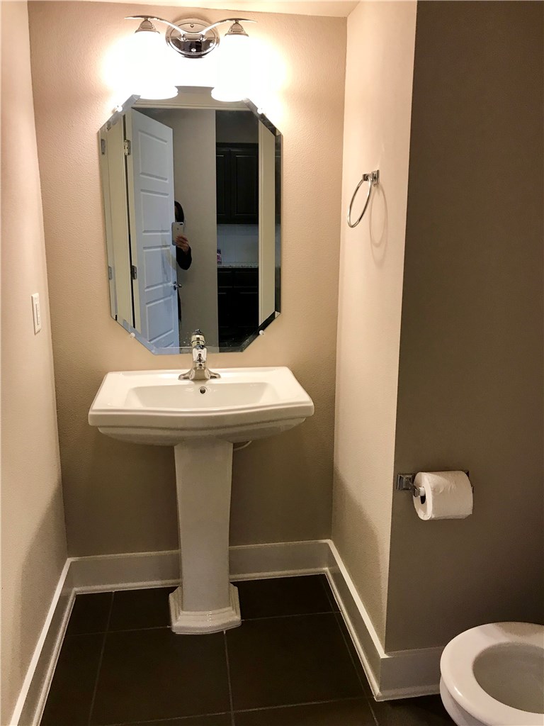 6814 East Riverside Drive, Unit 95 Austin, TX 78741 - Photo 20 of 23 a bathroom with a sink toilet and mirror