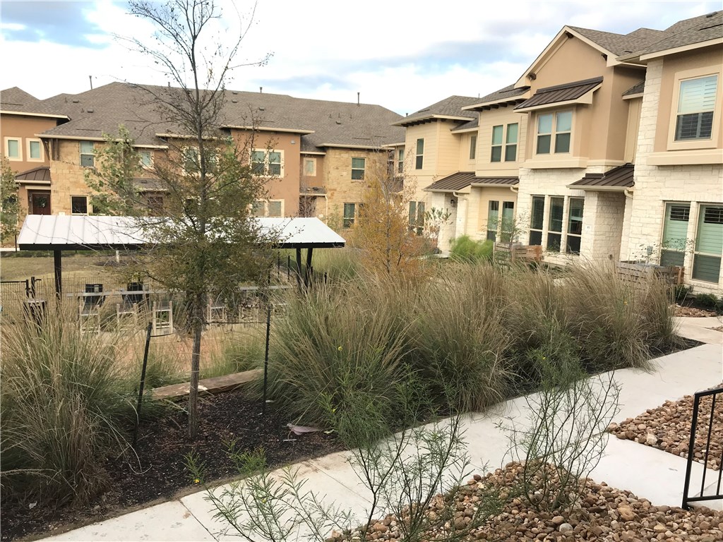 6814 East Riverside Drive, Unit 95 Austin, TX 78741 - Photo 21 of 23 a front view of a house with a yard