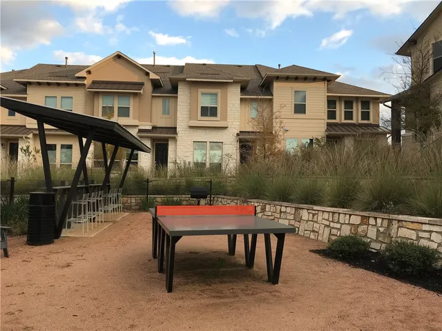 a backyard of a house with a yard and seating space