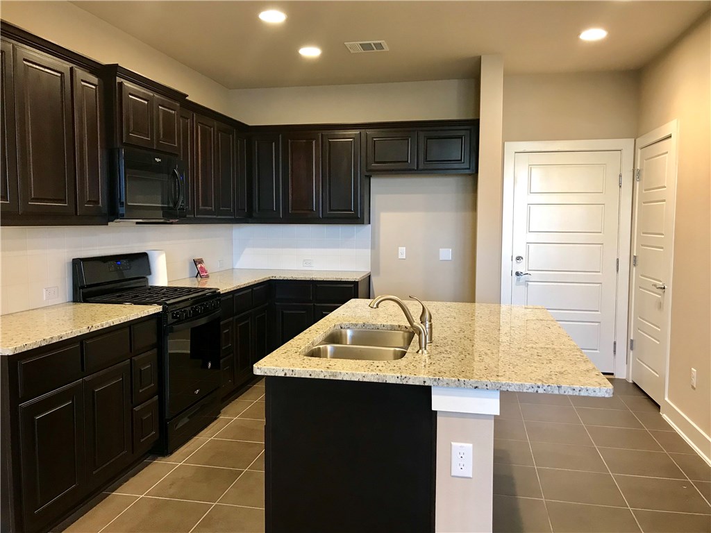 6814 East Riverside Drive, Unit 95 Austin, TX 78741 - Photo 4 of 23 a kitchen with a sink and cabinets