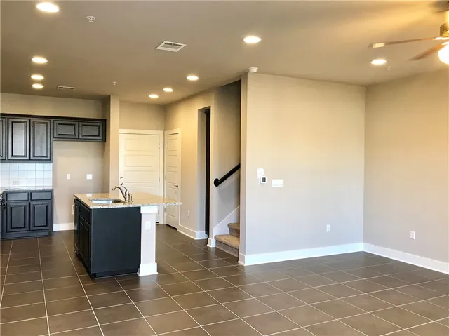 a kitchen with stainless steel appliances a refrigerator and a counter top space