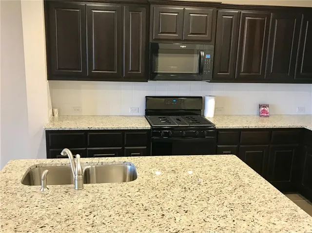 a kitchen with a sink and a microwave