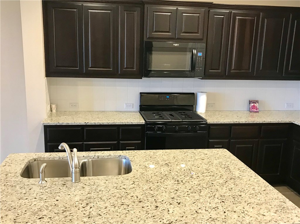 6814 East Riverside Drive, Unit 95 Austin, TX 78741 - Photo 7 of 23 a kitchen with a sink and a microwave