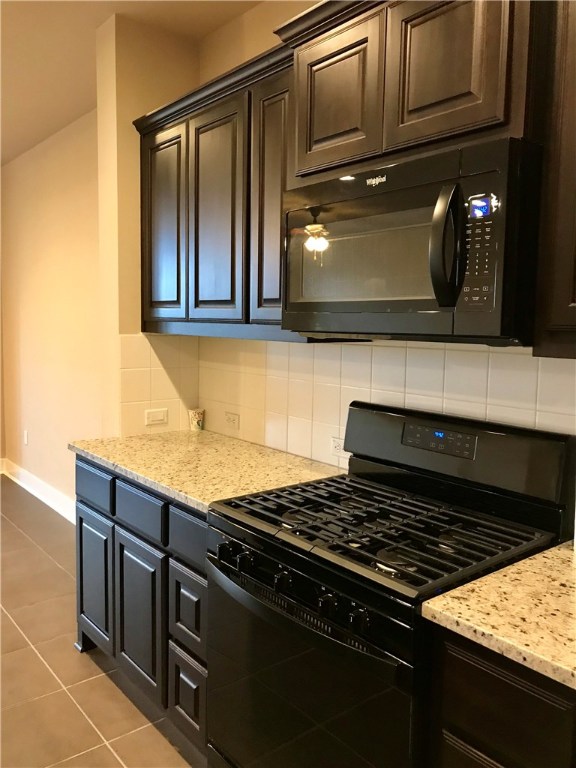 6814 East Riverside Drive, Unit 95 Austin, TX 78741 - Photo 9 of 23 a kitchen with granite countertop a stove and a microwave