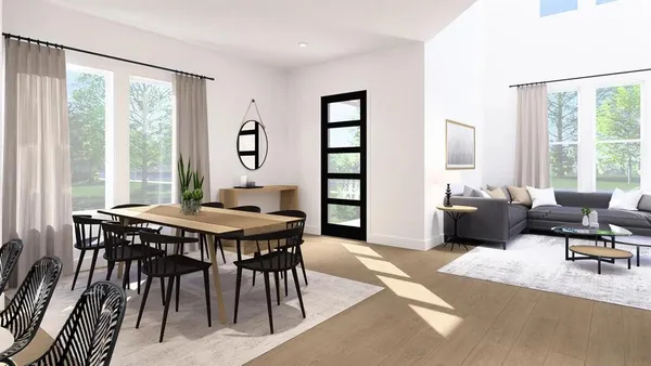 a living room with furniture and large windows