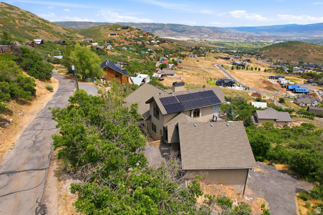 335 Bern Way Midway, UT 84049 - Photo 86 of 88 Hillside property featuring a multi-level structure with a gabled roofline and solar panels