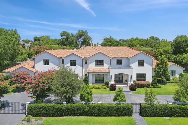 a aerial view of a house with a yard and potted plants