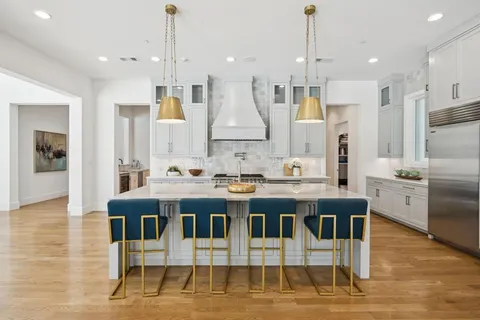 a large kitchen with a table and chairs