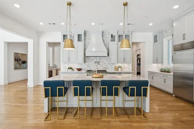 a large kitchen with a table and chairs