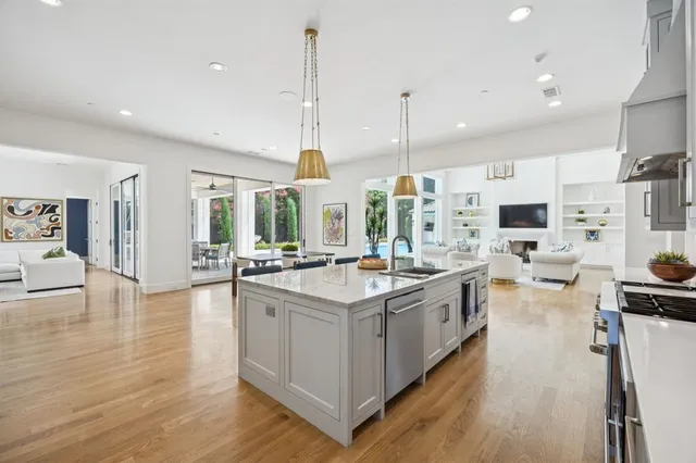 a large kitchen with stainless steel appliances a lot of counter space and wooden floor
