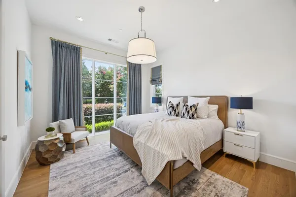 a bedroom with a bed mirror and window
