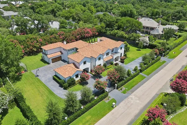 an aerial view of a house with swimming pool a patio and yard