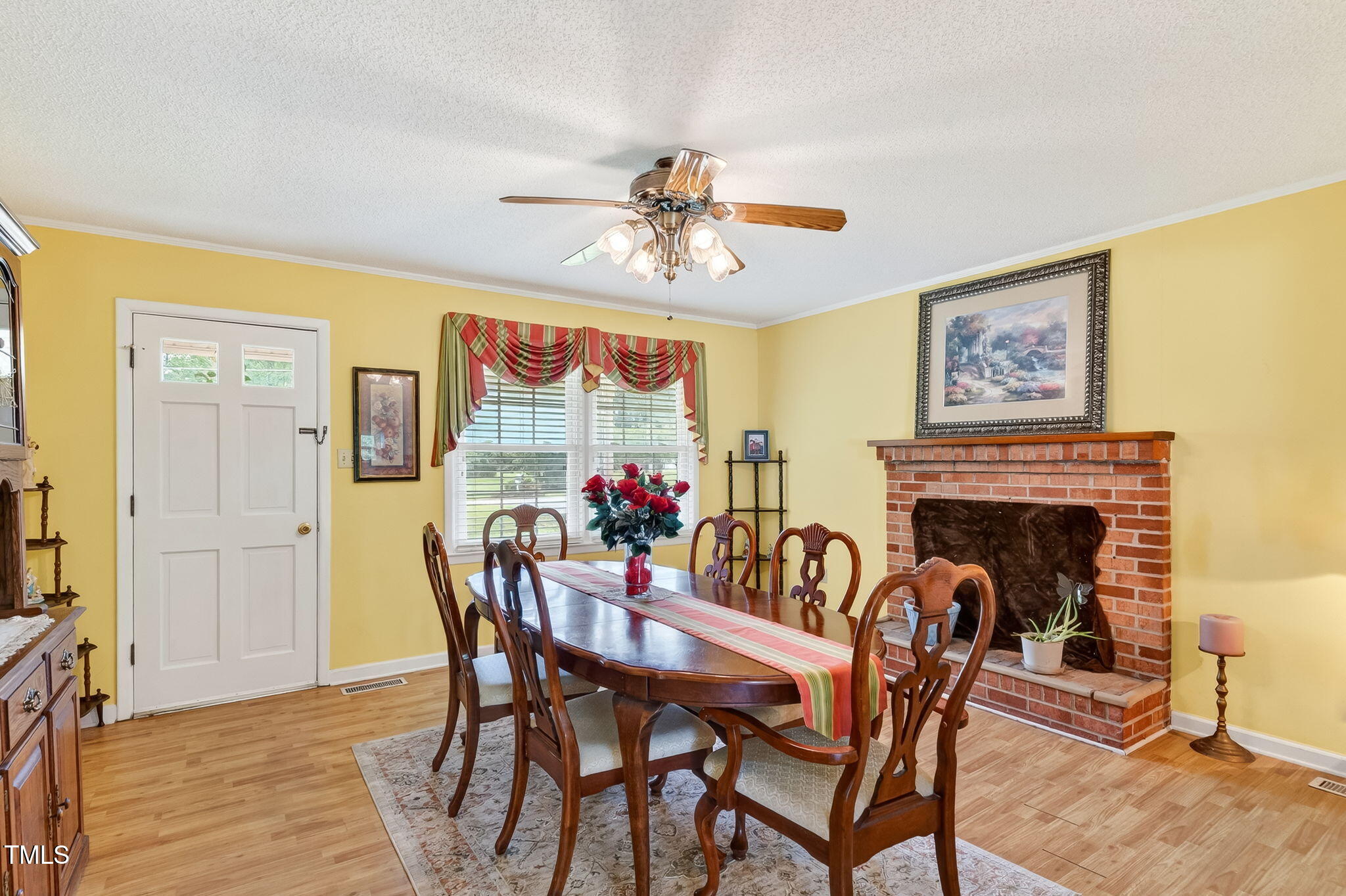 788 Gor An Farm Road Selma, NC 27576 - Photo 11 of 31 a dining room with furniture a fireplace and wooden floor