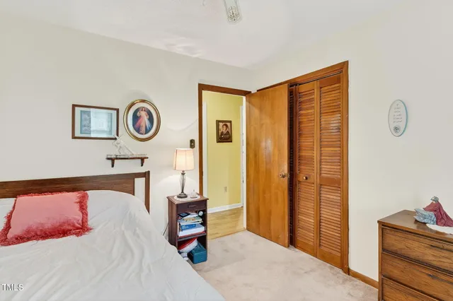 a bedroom with a bed and cabinets