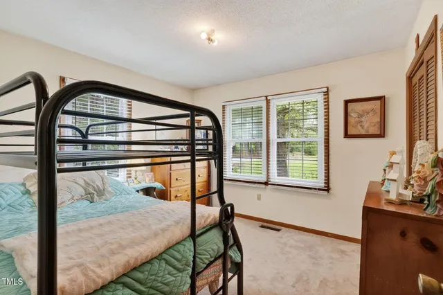 a view of entryway bedroom and hall with wooden floor