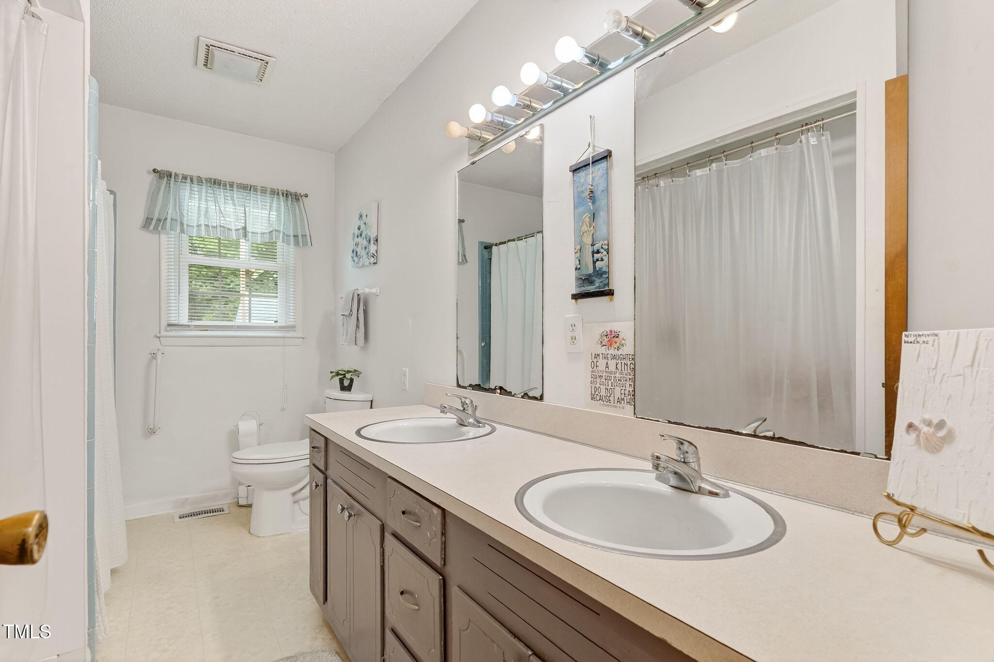788 Gor An Farm Road Selma, NC 27576 - Photo 20 of 31 a bathroom with a granite countertop double vanity sink a mirror and a toilet