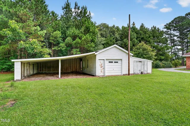 a view of a backyard with barn and large trees