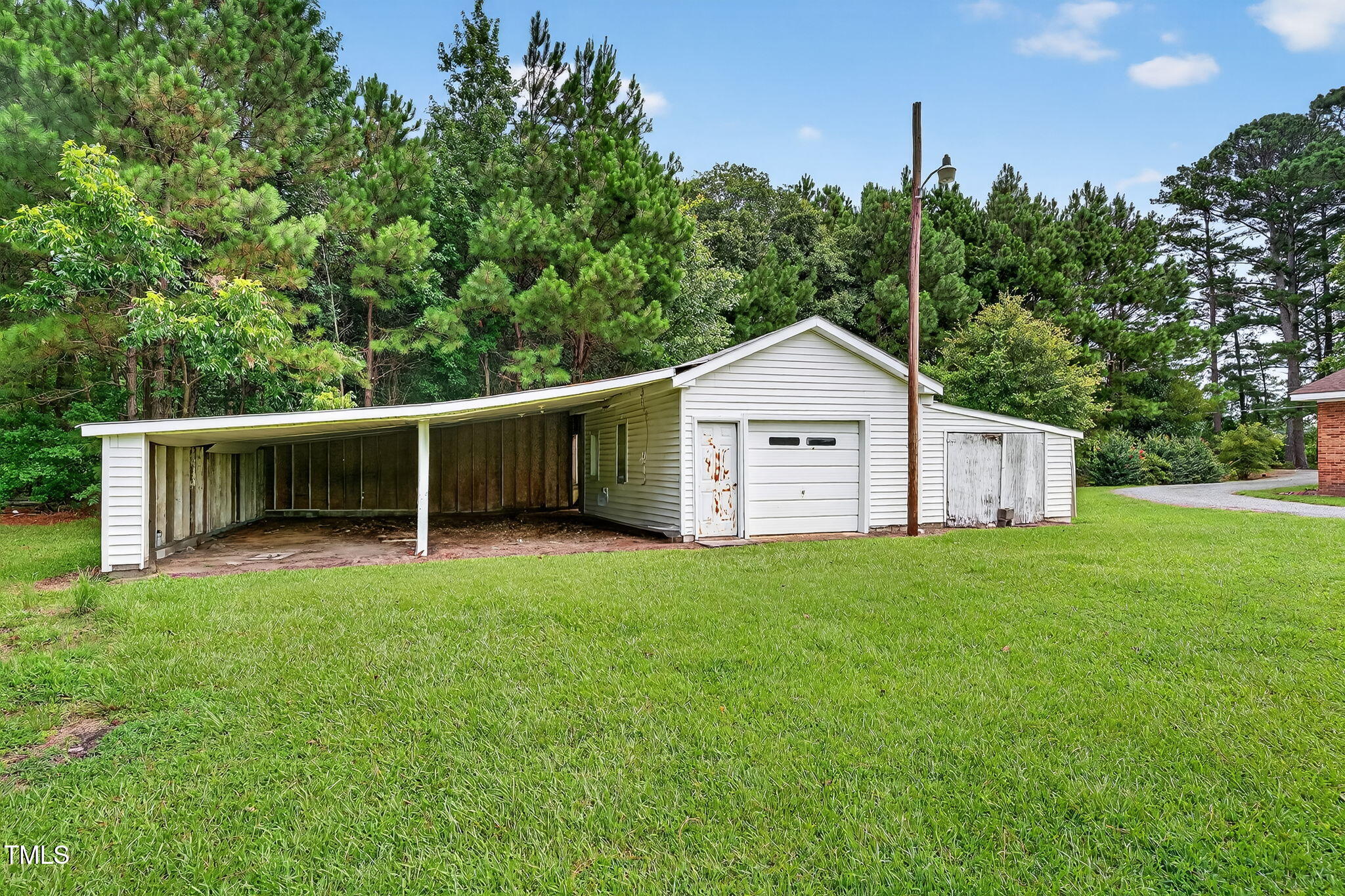 788 Gor An Farm Road Selma, NC 27576 - Photo 25 of 31 a view of a backyard with barn and large trees