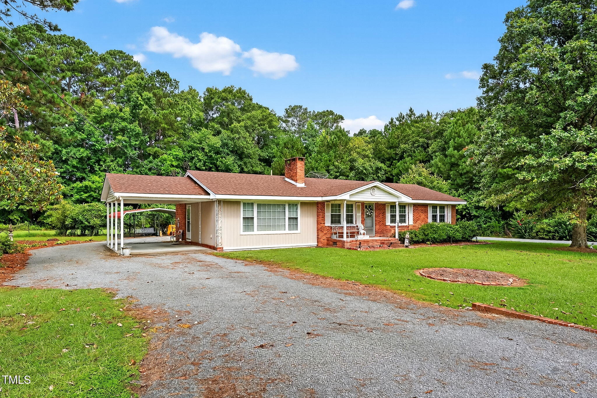 788 Gor An Farm Road Selma, NC 27576 - Photo 4 of 31 a front view of a house with a garden and trees