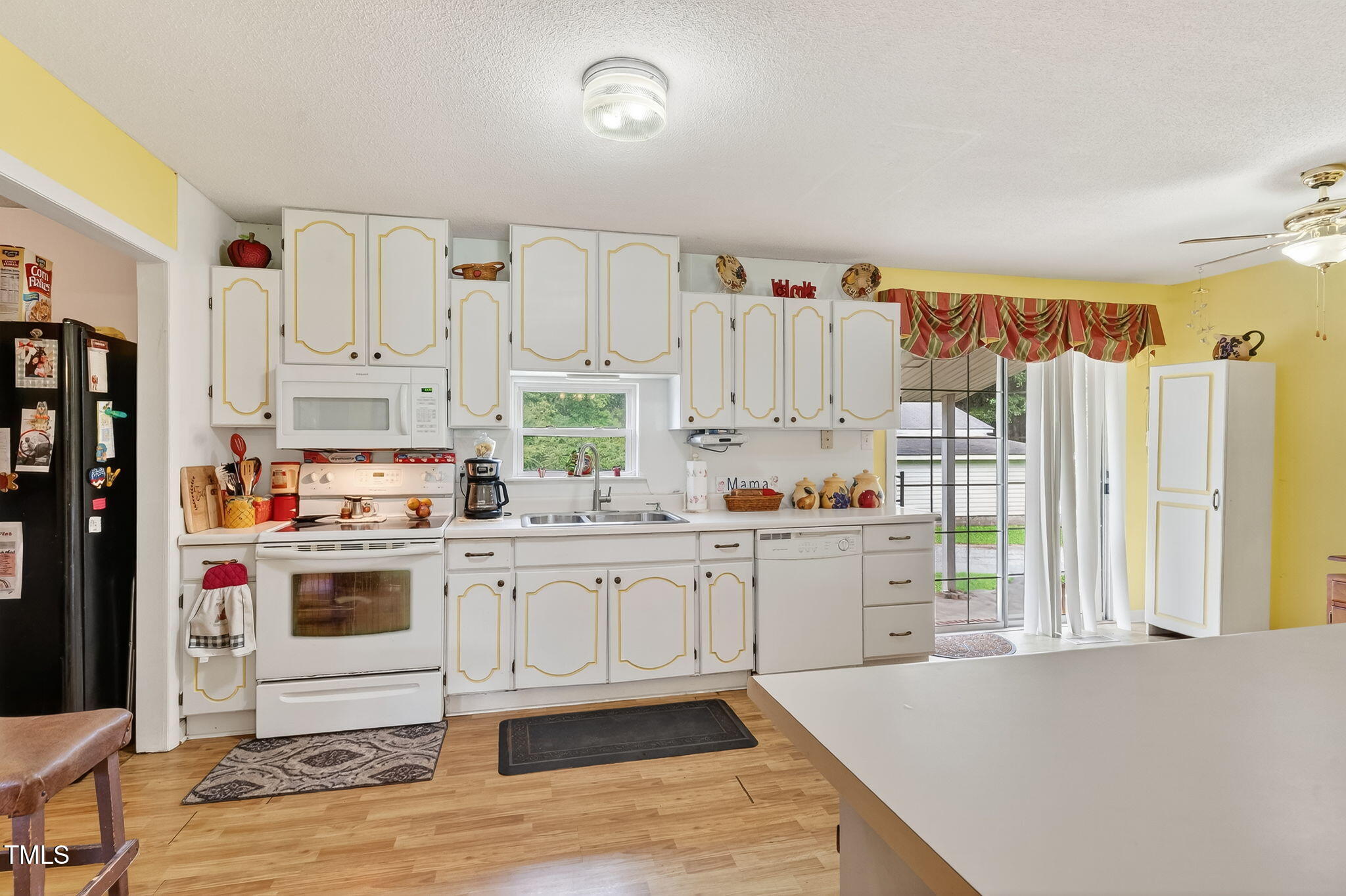 788 Gor An Farm Road Selma, NC 27576 - Photo 9 of 31 a kitchen with white cabinets and white appliances
