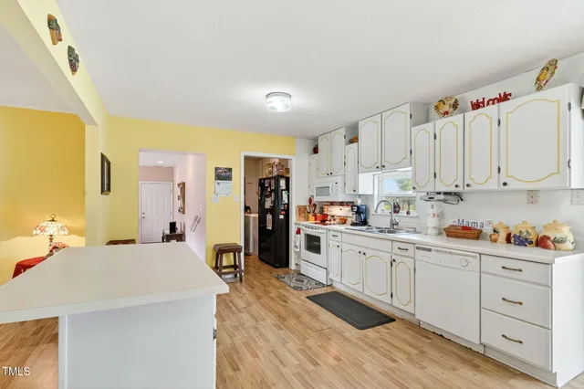a kitchen with cabinets a sink and appliances