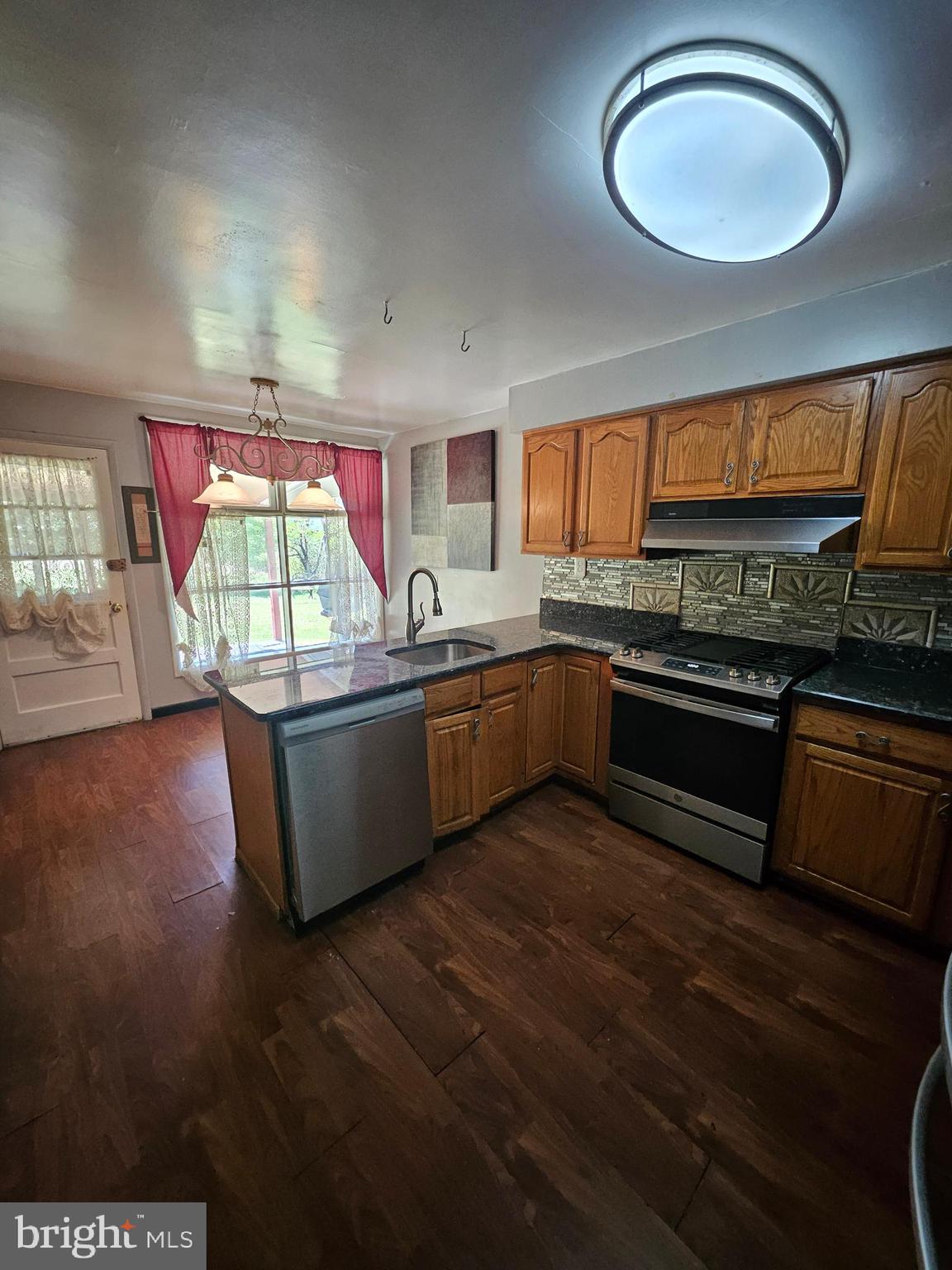 148 Church Road Elkins Park, PA 19027 - Photo 14 of 33 a kitchen with stainless steel appliances granite countertop a sink and a stove