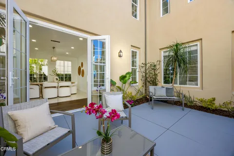 a view of a patio with couches and potted plants