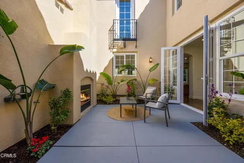 a living room with furniture potted plant and a large window