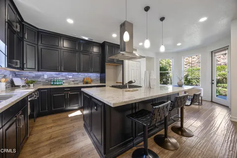a bathroom with a sink a toilet a mirror and shower
