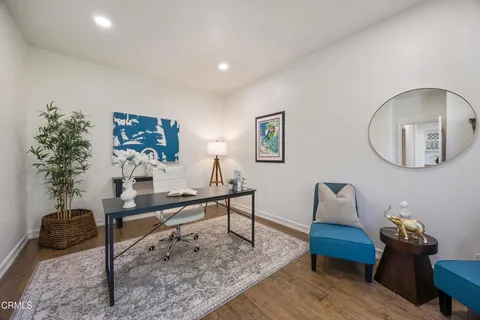 a spacious bedroom with a bed a couch and a large window