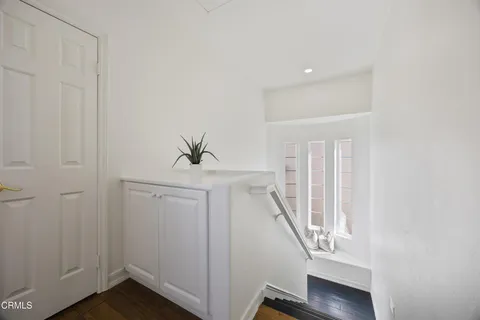 a spacious bedroom with a large bed and a chandelier
