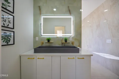 a view of a patio with table and chairs and potted plants