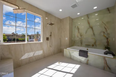 a view of a house with brick walls and a yard with a large tree
