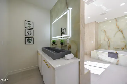 a view of a park with a bench and potted plants