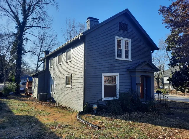 a view of a brick house with a yard