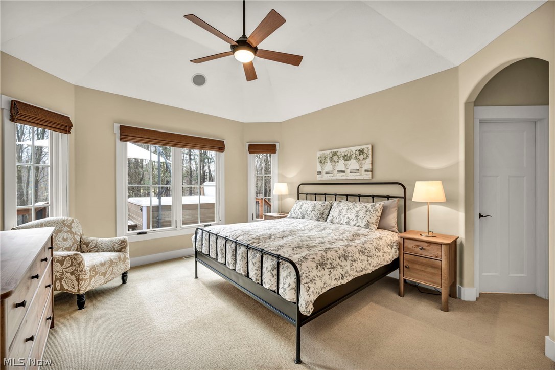 11295 Sutton Place Chardon, OH 44024 - Photo 20 of 50 Bedroom featuring light colored carpet, a ceiling fan, vaulted ceiling, and arched walkways