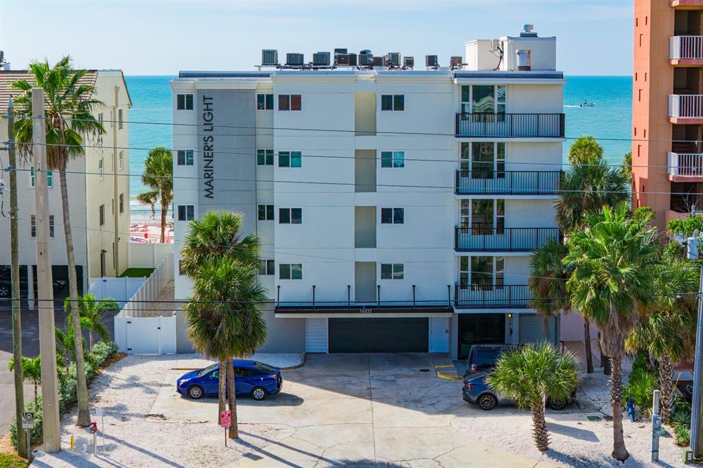 16332 Gulf Boulevard, Unit 3B Redington Beach, FL 33708 - Photo 48 of 91 a building with potted plants in front of it