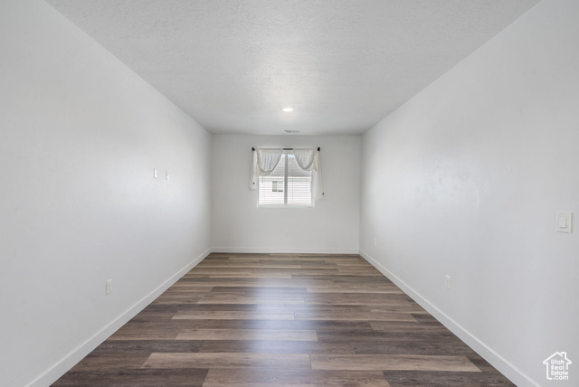 3456 South Linden Way Syracuse, UT 84075 - Photo 18 of 50 Spare room with baseboards, wood finished floors, and a textured ceiling
