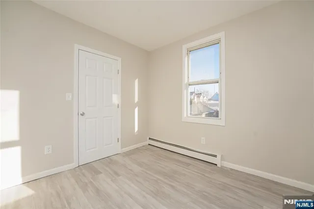 an empty room with windows and closet
