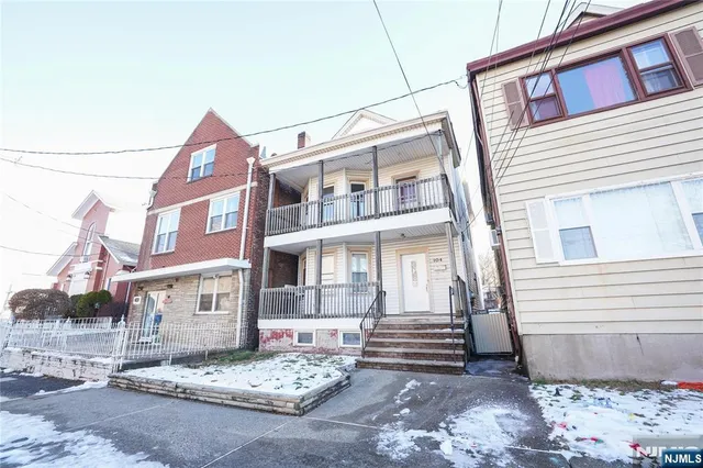 a view of a brick house with many windows