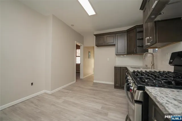 a kitchen with stainless steel appliances granite countertop a stove and a refrigerator