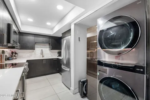 a kitchen with a sink cabinets and appliances