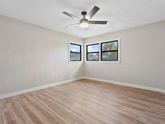 wooden floor in an empty room with a window
