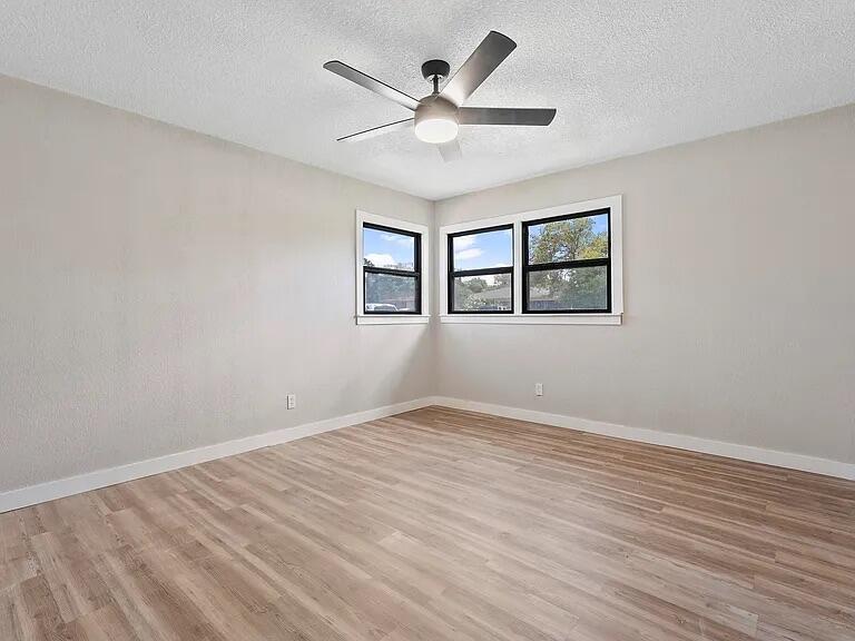 4308 43rd Street Lubbock, TX 79413 - Photo 16 of 18 wooden floor in an empty room with a window