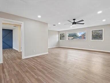 4308 43rd Street Lubbock, TX 79413 - Photo 4 of 18 a view of empty room with wooden floor and fan